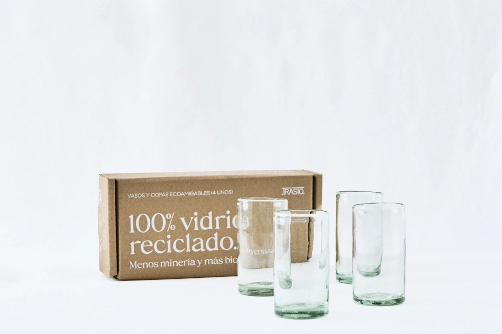 Four clear tall highball glasses, made from 100% recycled glass, shown side by side with packaging on a white background.