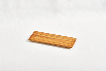 One short teak cheeseboard with beveled edges, displayed on a white background, showcasing its smooth surface and natural wood grain.