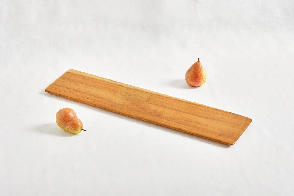 Long super lightweight cheeseboard tray made from 100% teak wood with beveled edges, shown from a diagonal perspective on a white background, highlighting its smooth surface and natural wood grain.