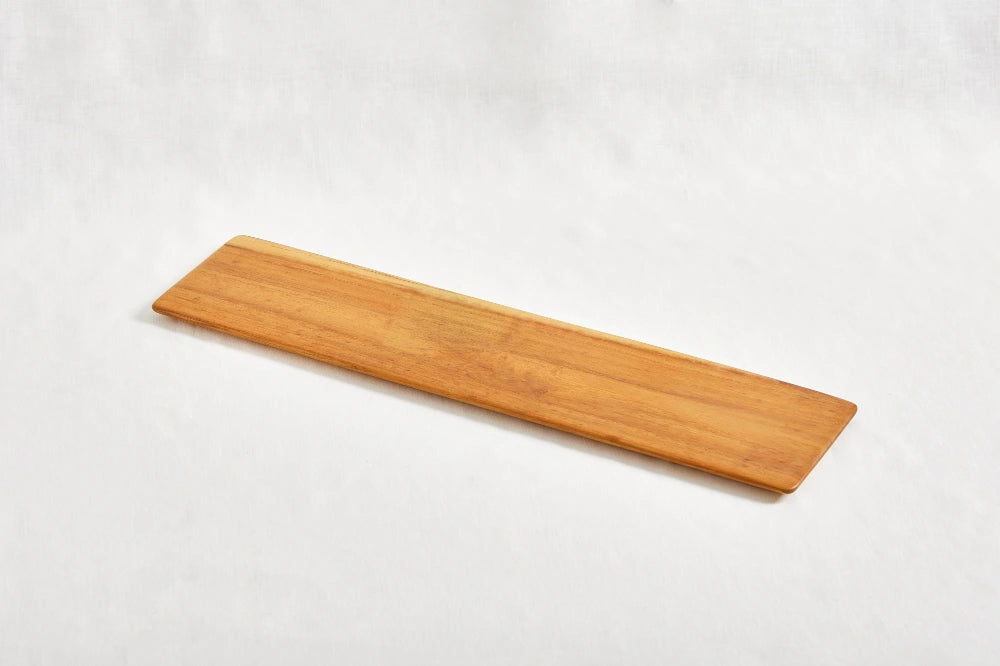 Long super lightweight cheeseboard tray made from 100% teak wood with beveled edges, shown from a diagonal perspective on a white background, highlighting its smooth surface and natural wood grain.